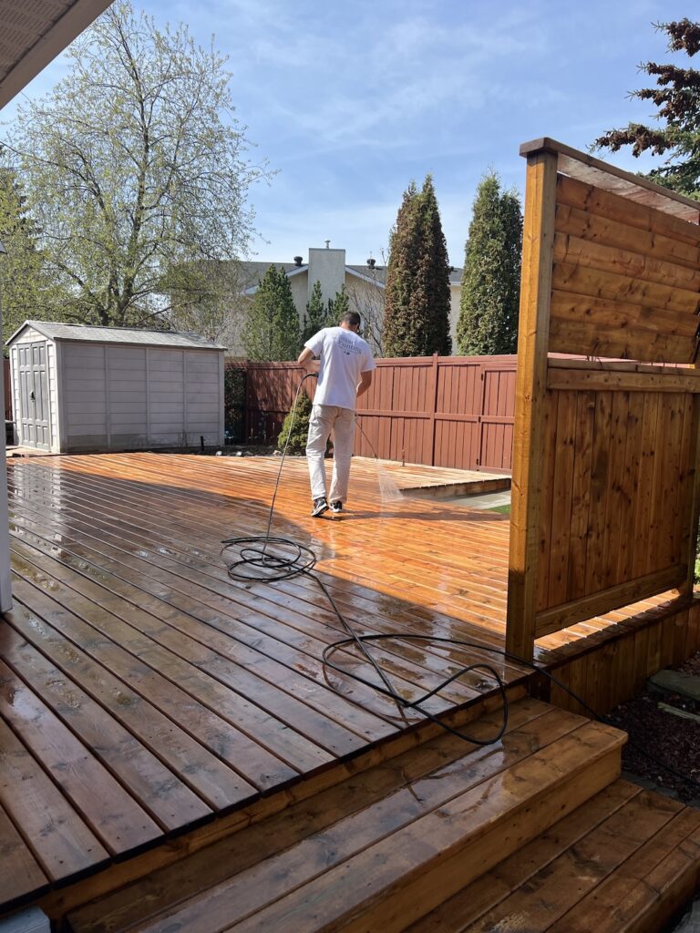 Professional deck staining service restoring a weathered wooden deck in Edmonton.