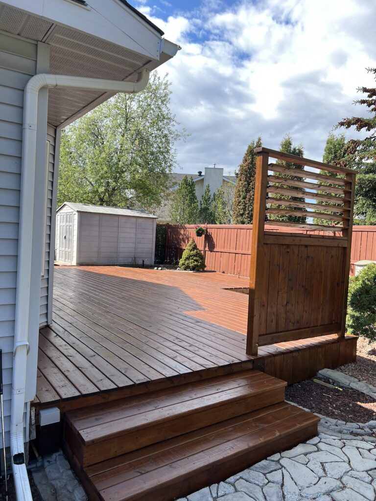 Freshly stained wooden deck with a rich brown finish in Edmonton.