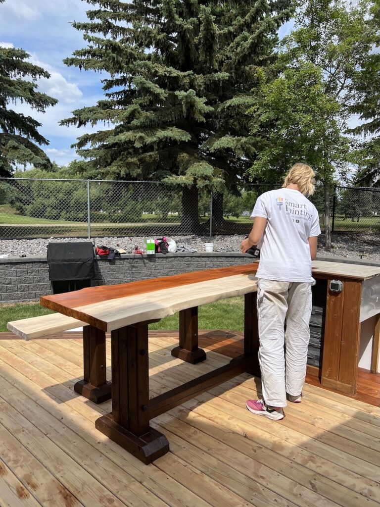 Freshly stained wooden deck with a rich brown finish in Edmonton.