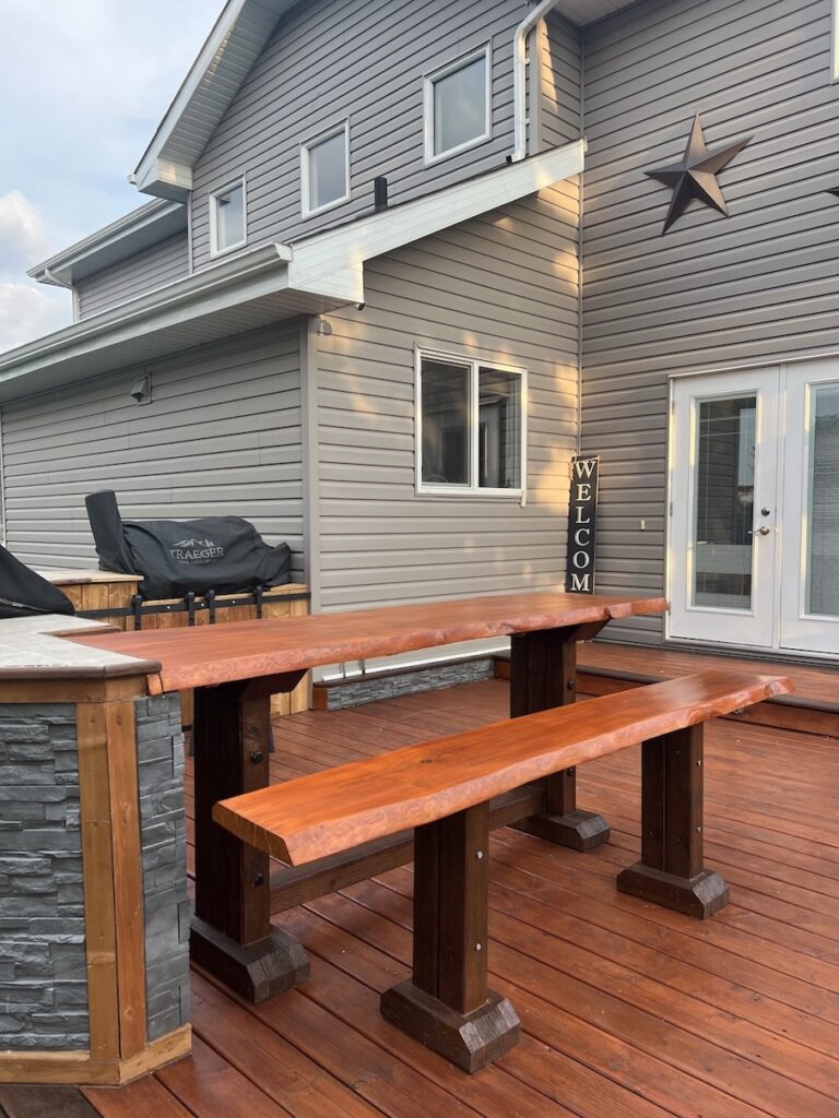 Freshly stained wooden deck with a rich brown finish in Edmonton.