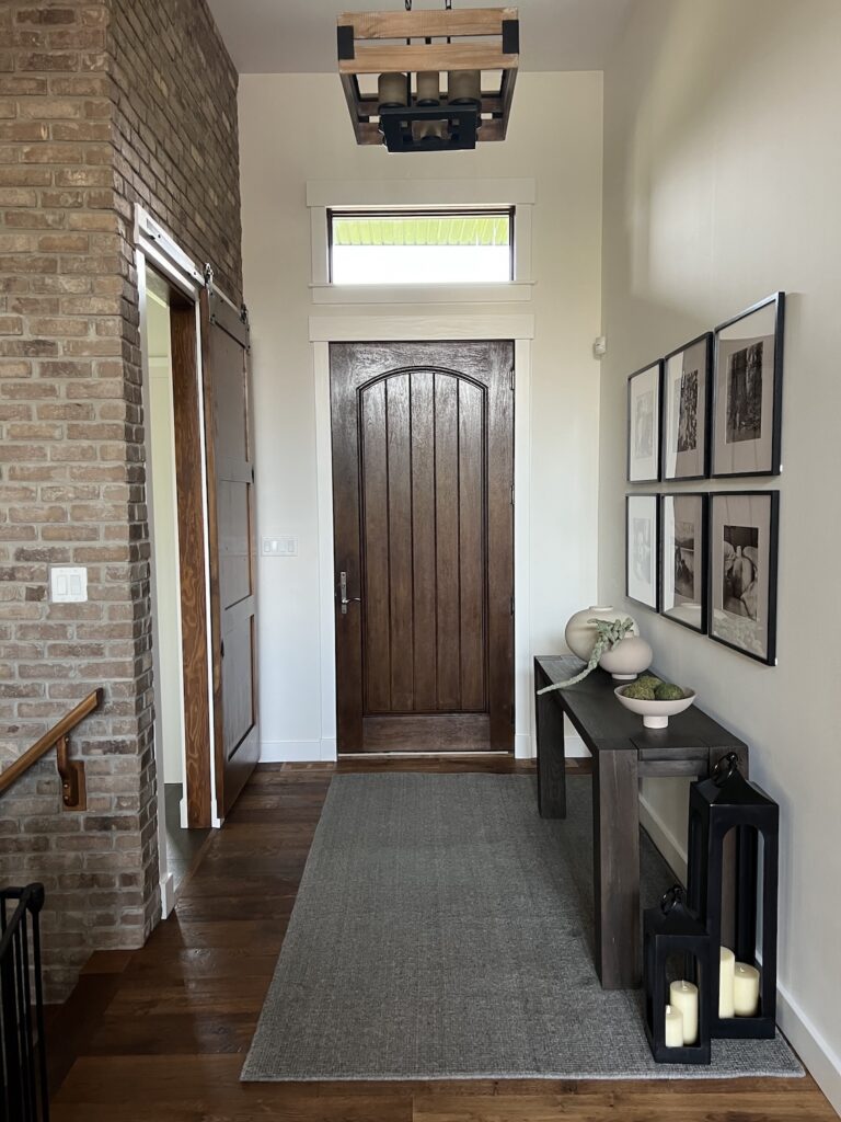 Professional painters applying fresh white paint to a modern living room in Edmonton.
