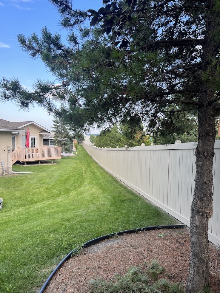 Freshly painted wooden fence with a smooth finish in Edmonton
