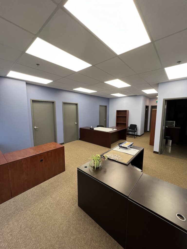 Repainting a commercial office building with modern gray tones for a refreshed look.