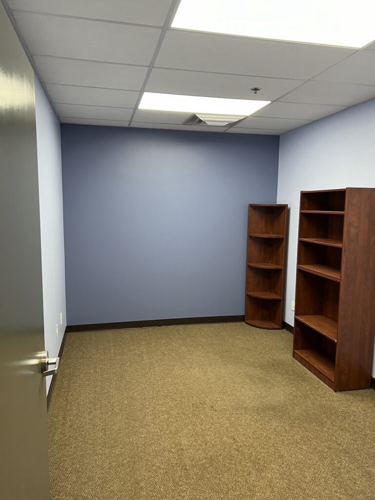 Repainting a commercial office building with modern gray tones for a refreshed look.