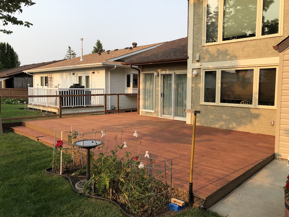 Freshly painted house with white trims after a professional exterior painting job.