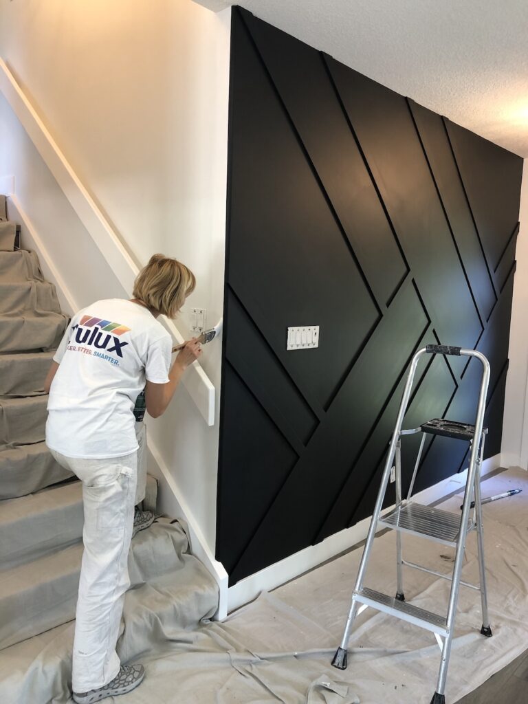 Dasha is straightening the lines with the brush