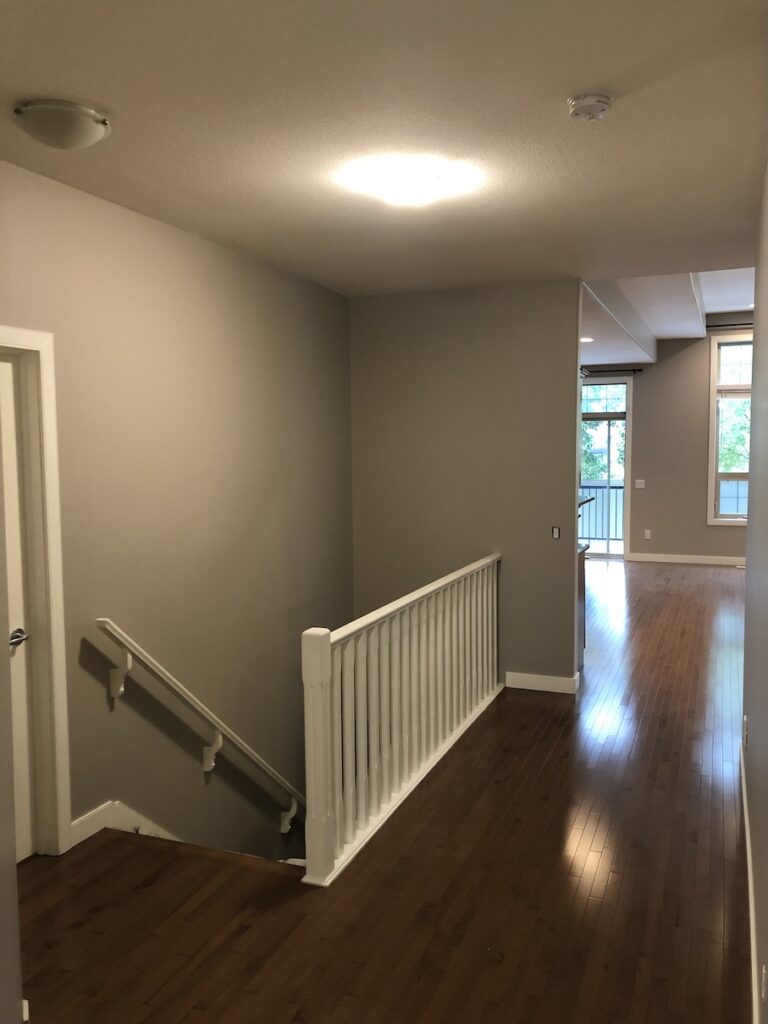 Elegant bedroom walls freshly painted in a soft gray tone by expert painters in Edmonton.